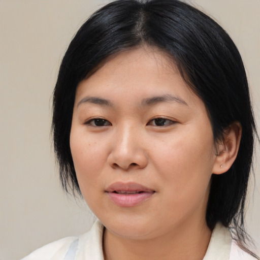 Joyful asian young-adult female with medium  black hair and brown eyes