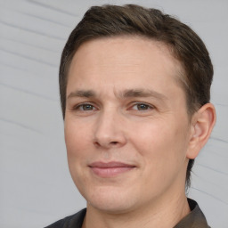 Joyful white adult male with short  brown hair and brown eyes