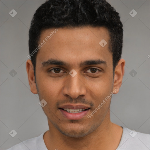 Joyful latino young-adult male with short  black hair and brown eyes