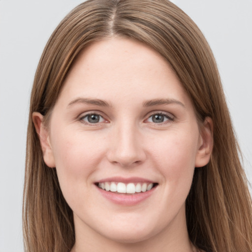 Joyful white young-adult female with long  brown hair and grey eyes