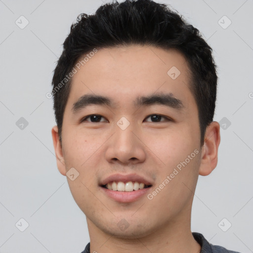 Joyful asian young-adult male with short  black hair and brown eyes