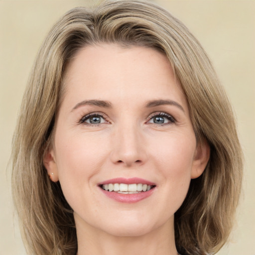 Joyful white young-adult female with medium  brown hair and green eyes