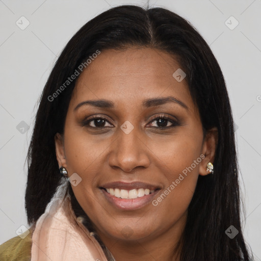 Joyful black adult female with long  brown hair and brown eyes