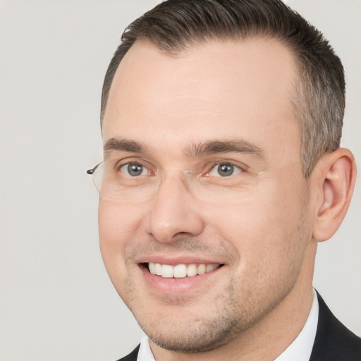 Joyful white adult male with short  brown hair and brown eyes