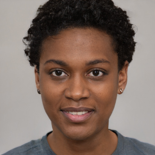 Joyful black young-adult female with short  black hair and brown eyes
