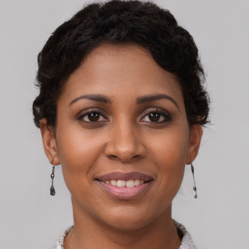 Joyful black young-adult female with short  brown hair and brown eyes