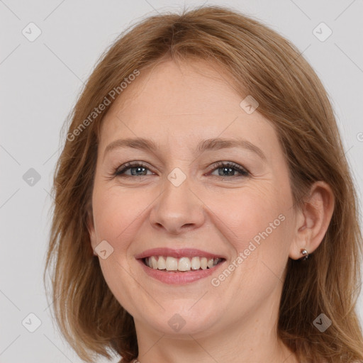 Joyful white adult female with medium  brown hair and grey eyes