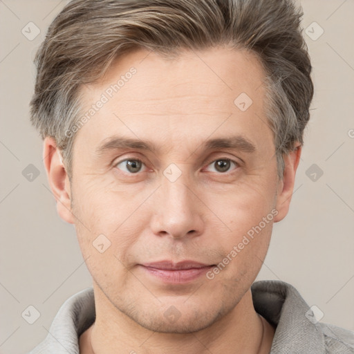 Joyful white adult male with short  brown hair and grey eyes