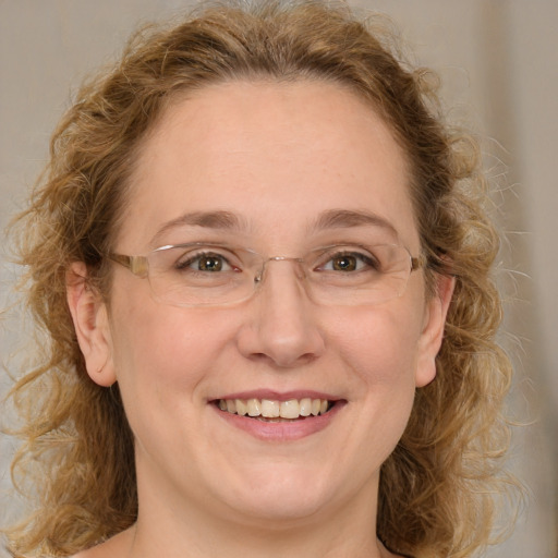 Joyful white adult female with medium  brown hair and green eyes