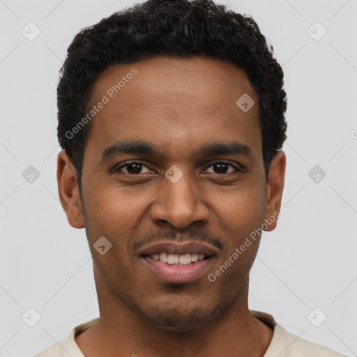 Joyful black young-adult male with short  brown hair and brown eyes