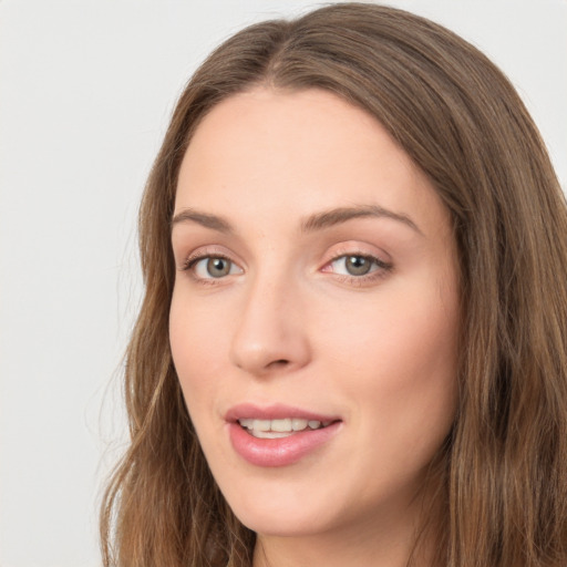 Joyful white young-adult female with long  brown hair and green eyes