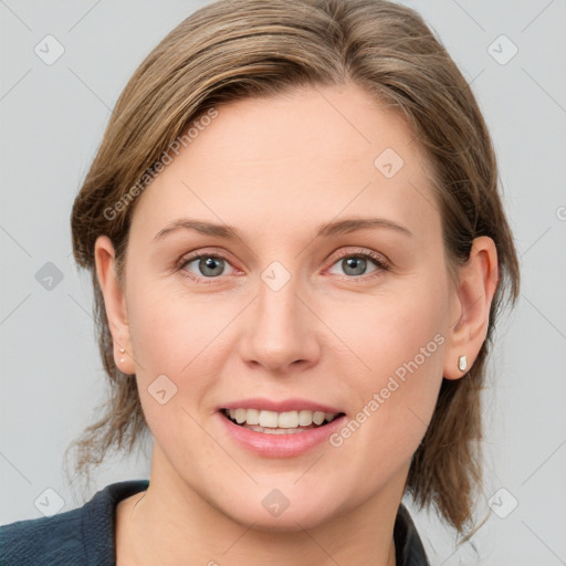 Joyful white young-adult female with medium  brown hair and blue eyes