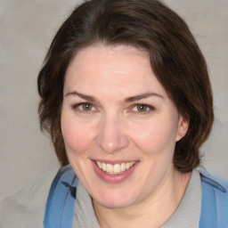 Joyful white adult female with medium  brown hair and blue eyes