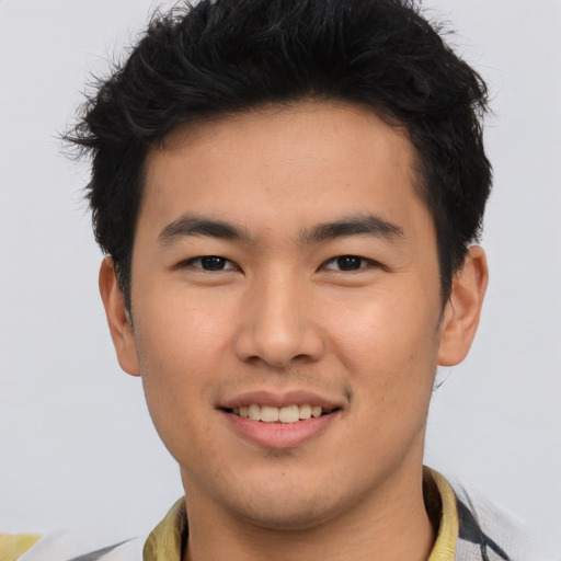 Joyful asian young-adult male with short  brown hair and brown eyes