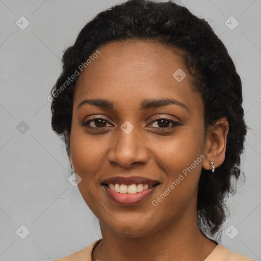 Joyful black young-adult female with long  black hair and brown eyes