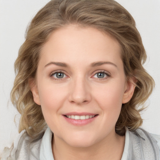 Joyful white young-adult female with medium  brown hair and green eyes