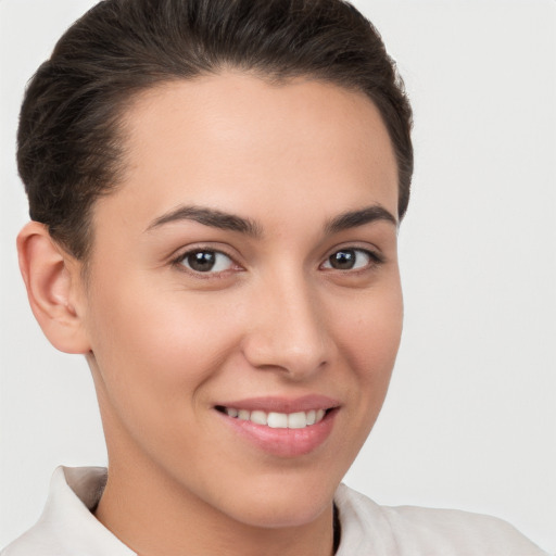 Joyful white young-adult female with short  brown hair and brown eyes