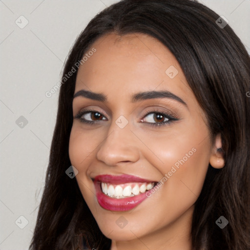 Joyful latino young-adult female with long  brown hair and brown eyes