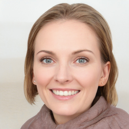 Joyful white young-adult female with medium  brown hair and blue eyes