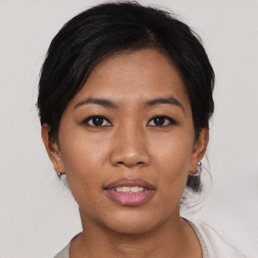 Joyful asian young-adult female with medium  black hair and brown eyes