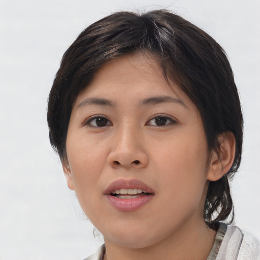 Joyful asian young-adult female with medium  brown hair and brown eyes