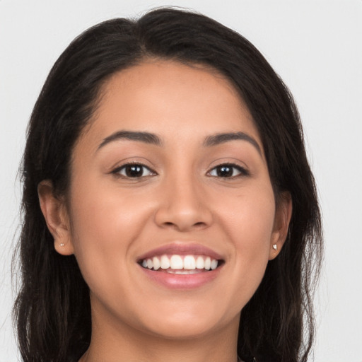 Joyful white young-adult female with long  brown hair and brown eyes