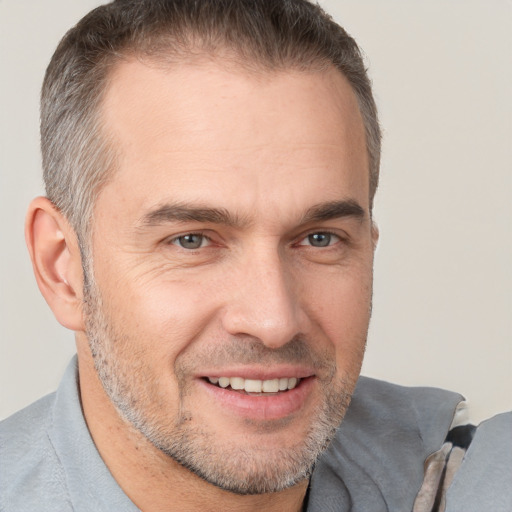 Joyful white adult male with short  brown hair and brown eyes