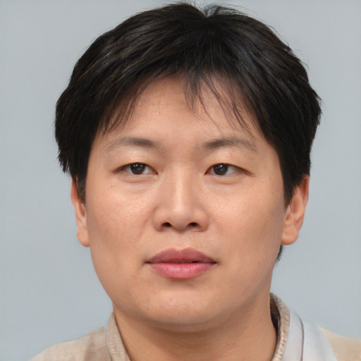 Joyful asian adult female with short  brown hair and brown eyes