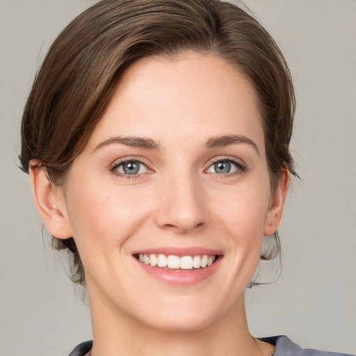 Joyful white young-adult female with medium  brown hair and grey eyes