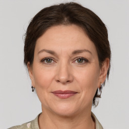 Joyful white adult female with medium  brown hair and grey eyes