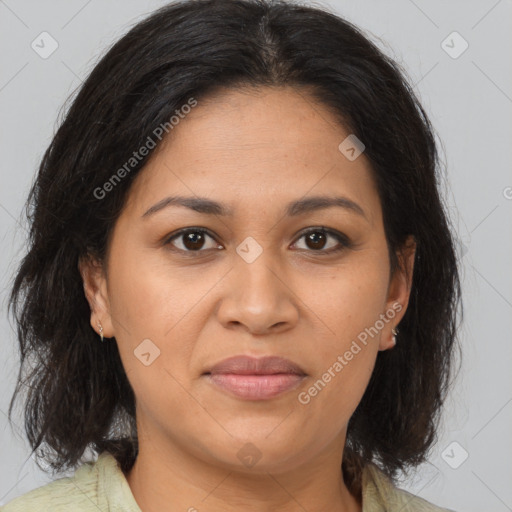 Joyful latino adult female with medium  brown hair and brown eyes