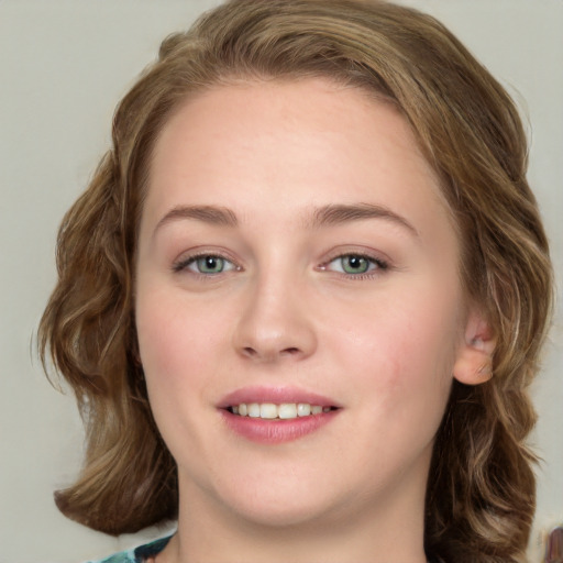 Joyful white young-adult female with long  brown hair and blue eyes