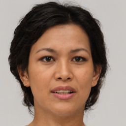 Joyful asian adult female with medium  brown hair and brown eyes