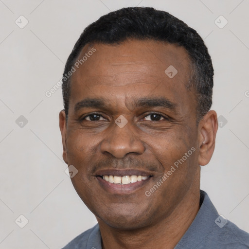 Joyful black adult male with short  black hair and brown eyes