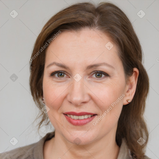 Joyful white adult female with medium  brown hair and grey eyes