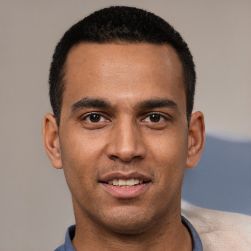 Joyful white young-adult male with short  black hair and brown eyes