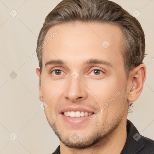 Joyful white young-adult male with short  brown hair and brown eyes