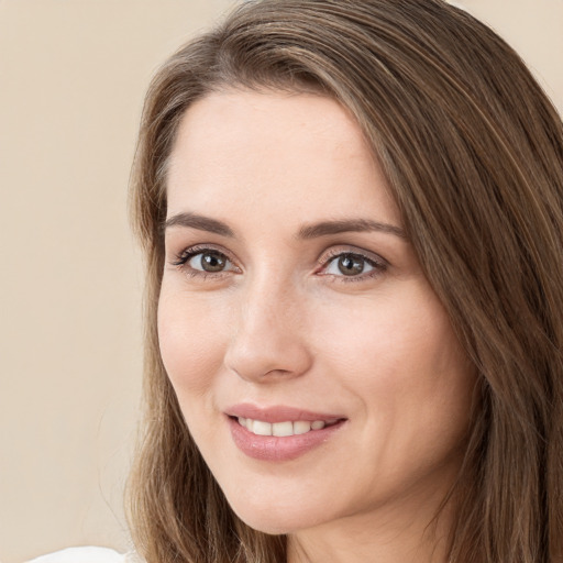 Joyful white young-adult female with long  brown hair and green eyes