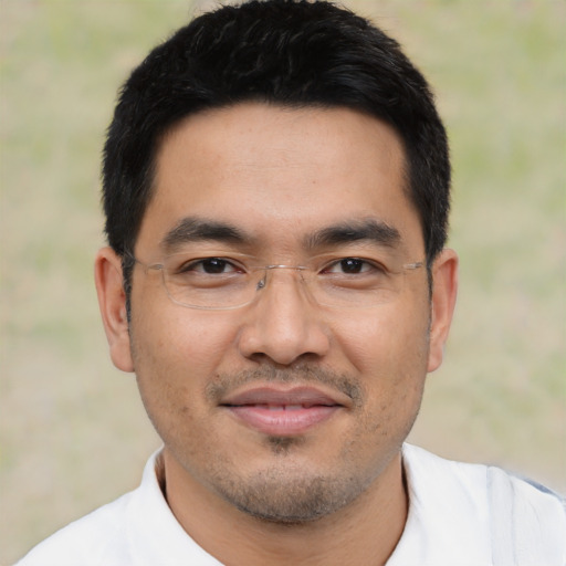 Joyful asian young-adult male with short  black hair and brown eyes