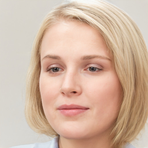 Joyful white young-adult female with medium  brown hair and blue eyes