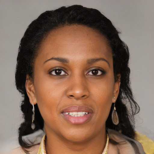 Joyful black young-adult female with medium  brown hair and brown eyes