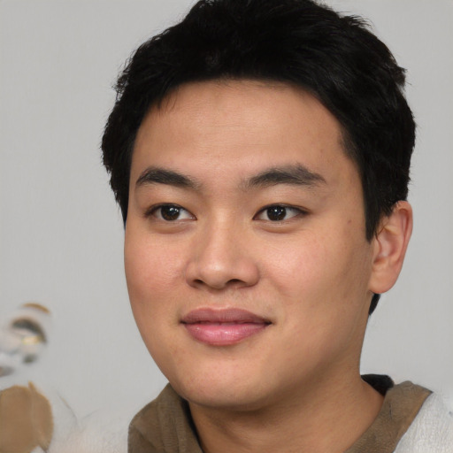Joyful asian young-adult male with short  black hair and brown eyes
