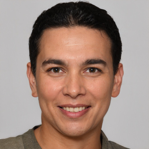 Joyful white young-adult male with short  black hair and brown eyes