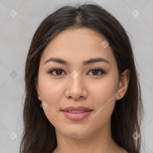 Joyful latino young-adult female with long  brown hair and brown eyes