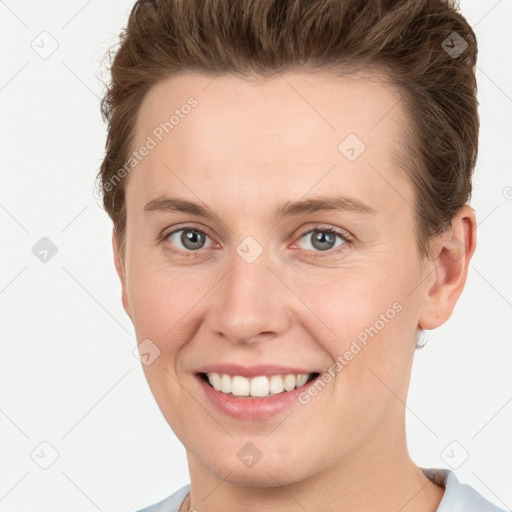 Joyful white young-adult female with short  brown hair and grey eyes