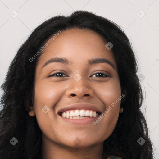 Joyful latino young-adult female with long  black hair and brown eyes