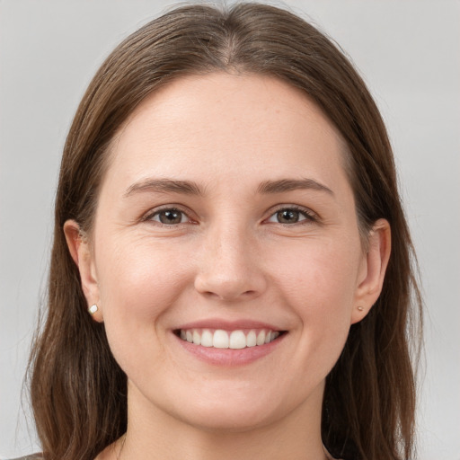 Joyful white young-adult female with long  brown hair and grey eyes