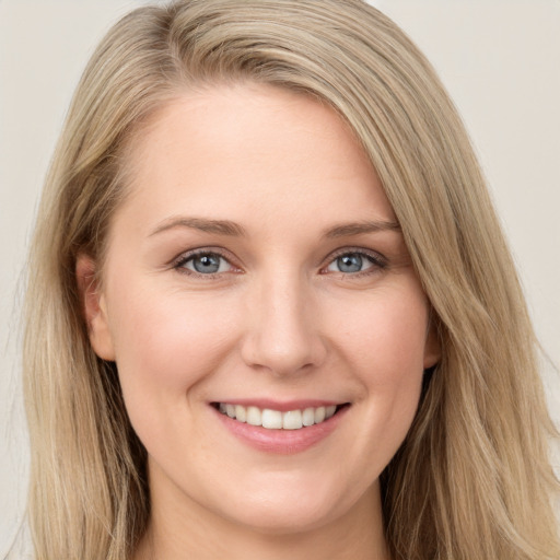 Joyful white young-adult female with long  brown hair and blue eyes