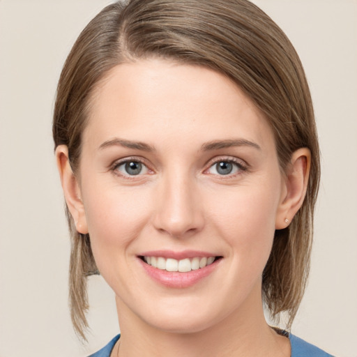 Joyful white young-adult female with medium  brown hair and blue eyes