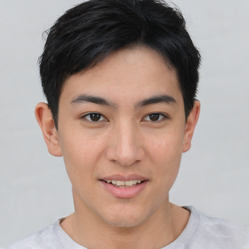Joyful asian young-adult male with short  brown hair and brown eyes